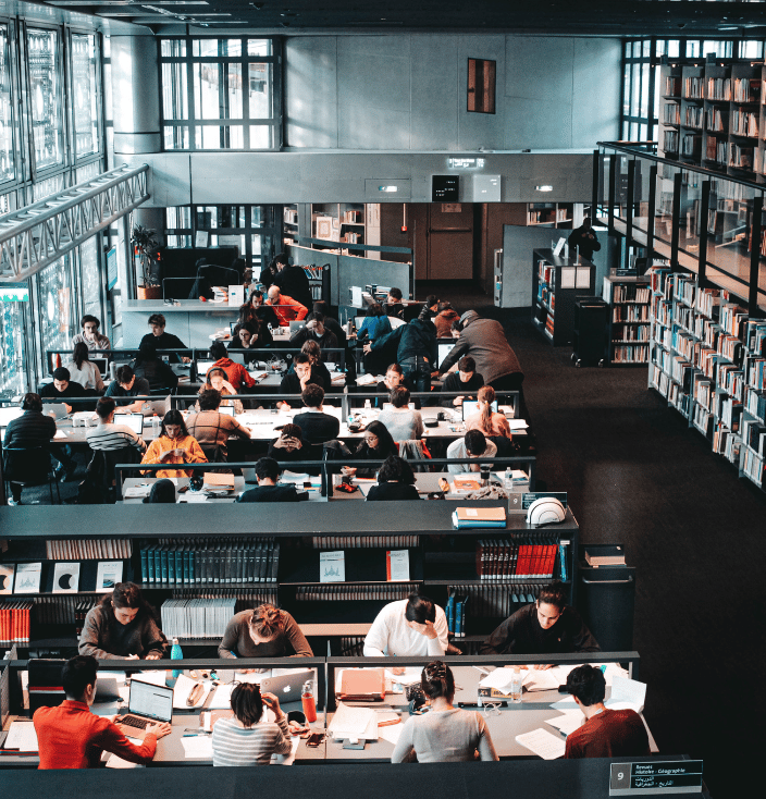 People sitting at tables in a library